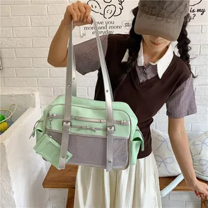 Asian model holding a mint green Japanese style JK shoulder bag with silver accents