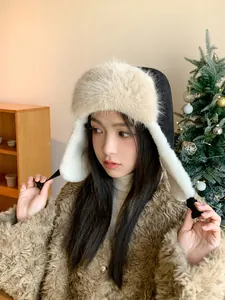 Model wearing a thick plush trapper hat with ear flaps in a cozy winter setting