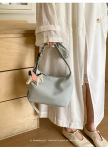 Minimalist leather hobo shoulder bag for women, chic underarm bag with cute pegasus charm.