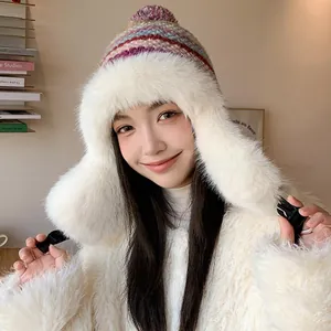 Stylish women's winter trapper hat with colorful knit pattern and plush white faux fur