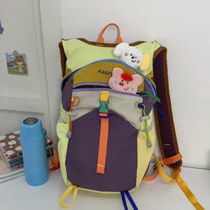Detailed view of the vibrant multi-color hiking backpack with cute plush accessories.