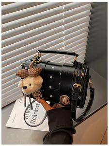 Retro black polka dot crossbody handbag featuring a cute teddy bear plush charm