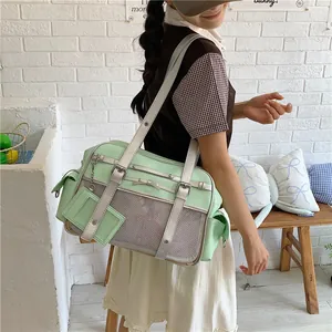 Model wearing a cute mint green Japanese style shoulder tote bag against a white wall