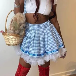Close-up view of the blue checkered pleated mini skirt with white lace trim detail