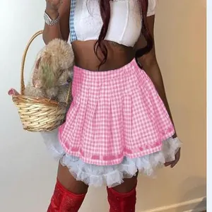 Detailed view of a pink gingham pleated mini skirt featuring white lace ruffle trim details.