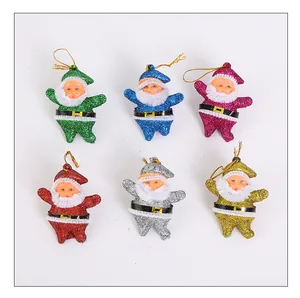 Macro detail of six colorful glitter Santa Claus hanging ornaments for Christmas decoration