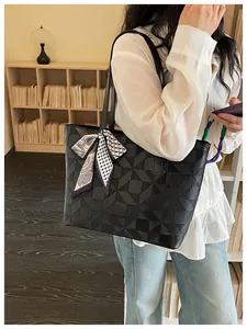 Black diamond quilted large capacity tote bag carried by a stylish model in library
