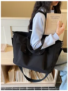 Large capacity black travel tote bag for women shown as a crossbody shoulder bag