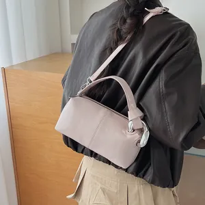 Stylish pink retro pillow bag for women featuring a unique knot handle design on model