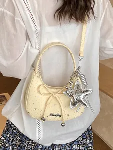 Trendy sweet cream yellow dumpling bag with bowknot detail and silver star charm pendant