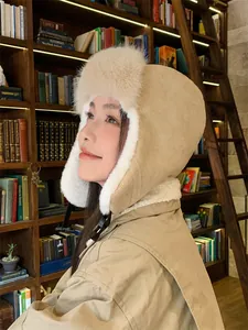 Side view of beige trapper hat with soft faux fur lining for extra winter warmth