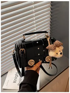 Vintage black polka dot crossbody bag with cute plush teddy bear charm accessory