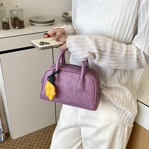 Elegant purple Boston handbag for women with a cute yellow pineapple charm detail