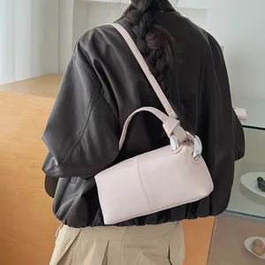Side view of a pale pink pillow handbag with silver chain link hardware detail