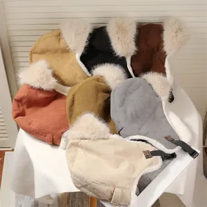 Collection of various colorful corduroy trapper hats with soft faux fur lining for winter