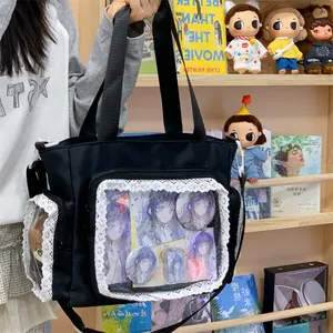 Detailed view of a large black lace-trimmed ita bag with clear display windows for pins