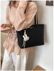 Minimalist large capacity commute tote bag for women, stylish shoulder bag with charm.