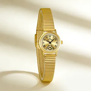 Vintage gold-tone small round watch with stretchable bamboo band for elegant women.