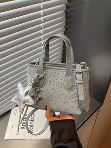 Premium light blue denim small handbag with silver studs and star charm accessory