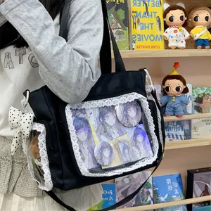 Detailed view of black canvas ita bag featuring a lace-trimmed clear display pocket