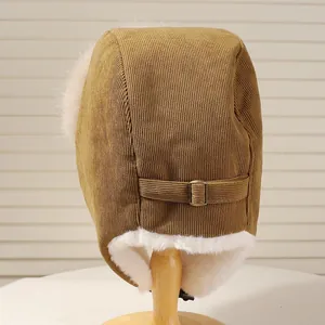 Detailed back view of a warm corduroy trapper hat with soft white faux fur lining.
