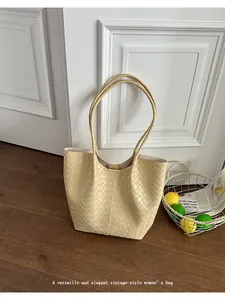 Close-up showcasing the elegant woven texture of this cream vintage style tote bag