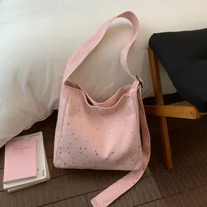 Detailed view of a pink canvas shoulder bag with sparkling silver star sequins and large capacity