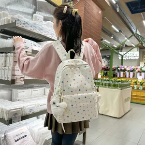 Japanese style school backpack with cute star pattern worn by a student in a store