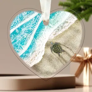 Detailed heart-shaped acrylic ornament featuring a vibrant sea turtle on a sandy beach.