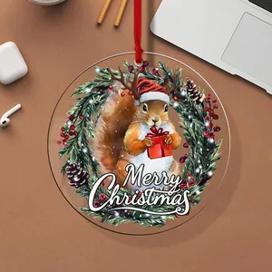Close-up of circular acrylic Christmas ornament with squirrel and wreath design