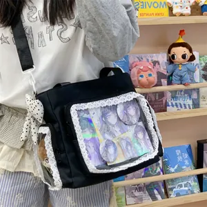 Black lace ita bag with clear windows displaying anime badges and character cards.
