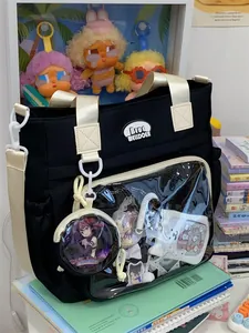Black canvas ita bag with clear window showing anime pin collection and accessories