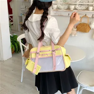 Japanese style yellow and pink anime ita bag shown being worn by a girl in a cafe setting