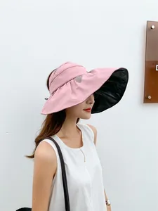 Side profile of a woman wearing a pink UV-protection sun hat with black vinyl lining