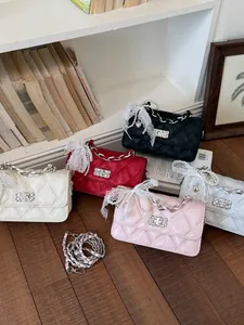 Set of quilted shoulder bags with lace and pearl decorations in multiple colors.