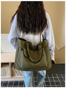 Rear view of model carrying olive green large capacity tote bag in casual setting