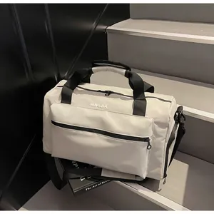 Large capacity travel duffel bag in beige on steps, modern gym luggage style view.