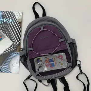 Vista detallada de mochila deportiva gris y violeta con bolsillo de red y cordones elásticos