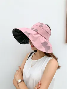 Side view of a pink butterfly sun hat with black vinyl lining for UV protection.