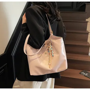 Stylish glossy pink large capacity tote bag shown on a model for chic casual commuting