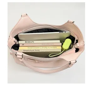 Large capacity pink women's tote bag showing interior storage with laptop and books