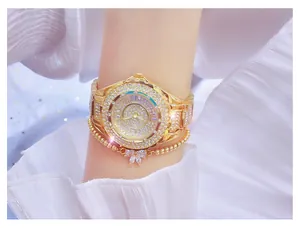 Close-up of gold-tone women's watch encrusted with rhinestones and matching bracelet
