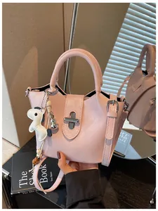 Vue détaillée d'un sac seau rose design avec un charmant détail en forme de chien.