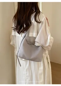 Minimalist retro hobo underarm bag detail, soft grey PU leather shoulder bag for women.