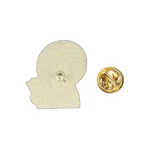 Detailed back view of a golden cartoon enamel pin with a butterfly clutch fastener