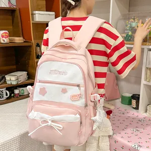 Back view of a cute pink star print school backpack on a student in a cozy study room