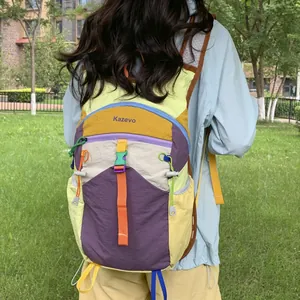 Back view of a vibrant dopamine-colored hiking backpack shown in an outdoor park setting