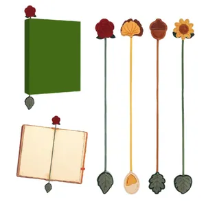 Close-up detail of vintage leather bookmarks featuring rose, sunflower and ginkgo motifs