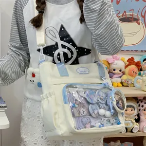 Detailed view of canvas tote bag with clear window pocket for anime badges display.