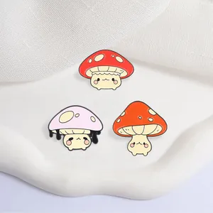 Close-up detail of three colorful cartoon mushroom pins with anthropomorphic faces